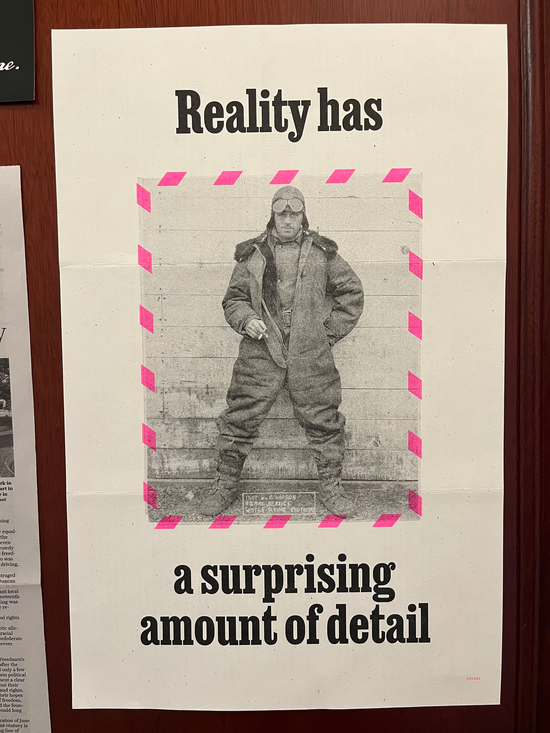 Picture of a poster with a photograph of an early twentieth century pilot and the phrase Reality has a surprising amount of detail